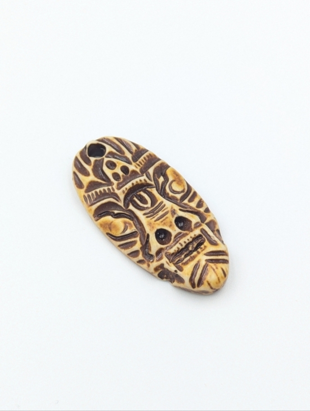 5/25$  Carved mask bone pendant